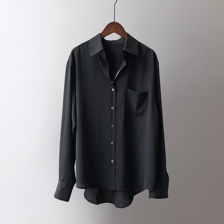Elegant pastel blue flowing blouse with long sleeves, offering a sophisticated look and comfortable feel for women.