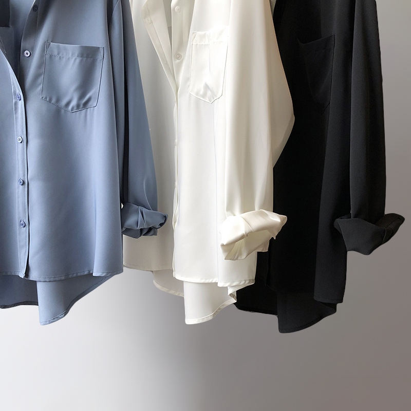 Women's flowing blouse, a versatile long-sleeve top in pearl black, featuring an elegant design and high-low hem.