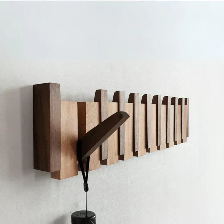 Elegant piano design wall mounted coat rack with multiple hooks, perfect for entryway organization.
