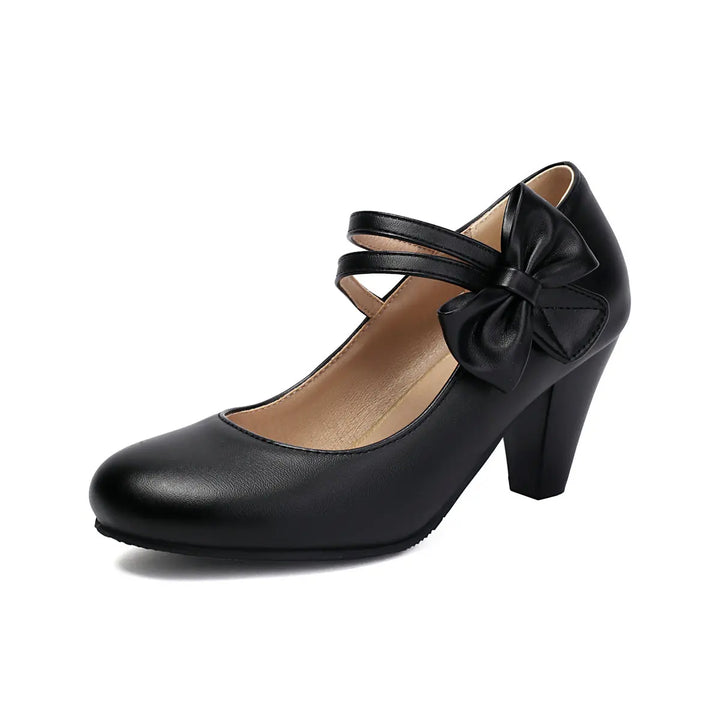 Stylish ankle strap block heels for women, with an elegant bow, ideal for formal or party wear.