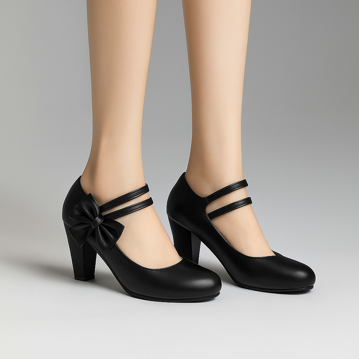 White elegant block heels with a charming bow detail, ideal for women's formal events or bridal wear.