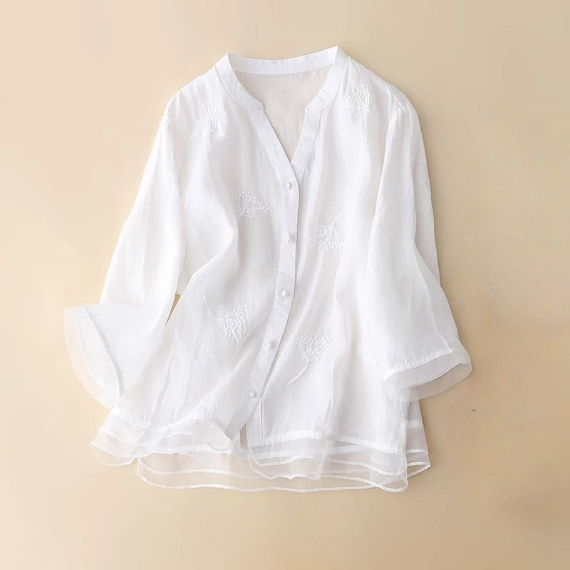 Sophisticated purple women's v-neck blouse, detailed with delicate embroidery and a chic layered hem for elegant everyday wear.