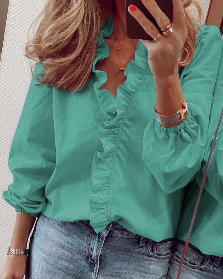 Stylish white ruffled V-neck blouse for women, an elegant long sleeve top suitable for any occasion.