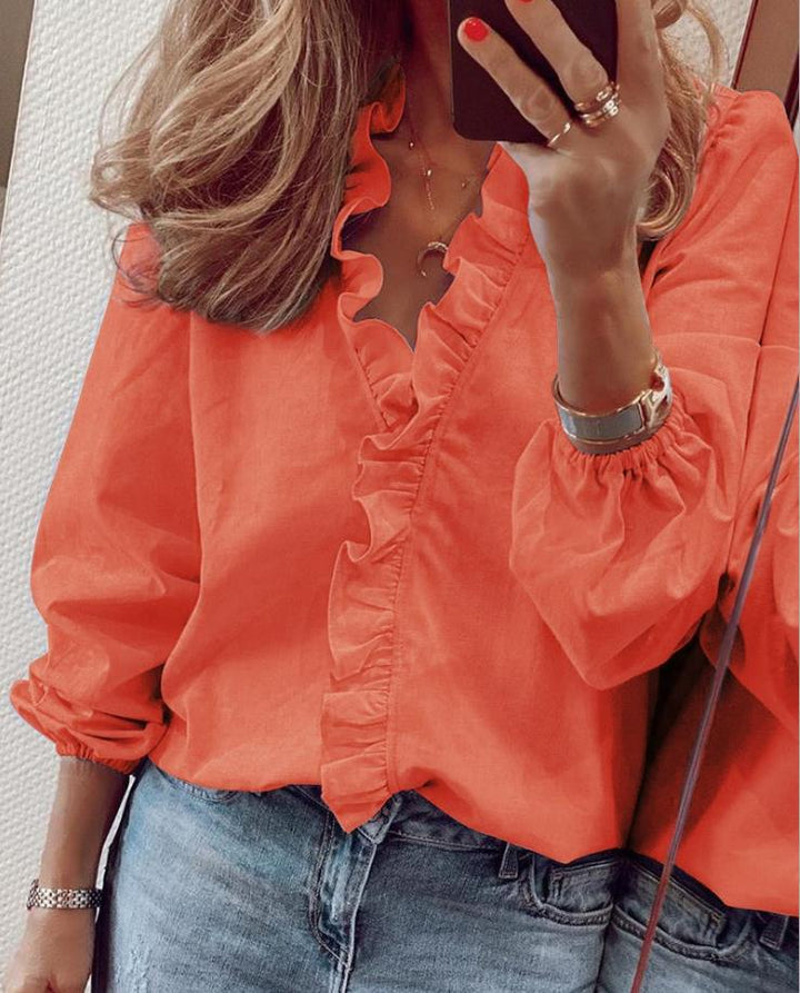 Trendy green ruffled V-neck blouse with long sleeves, a chic and comfortable top for modern women.