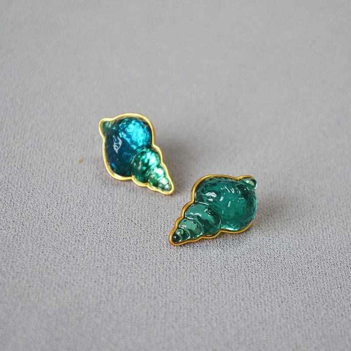 Close-up of elegant sea blue shell earrings, showcasing their vintage design and quality.