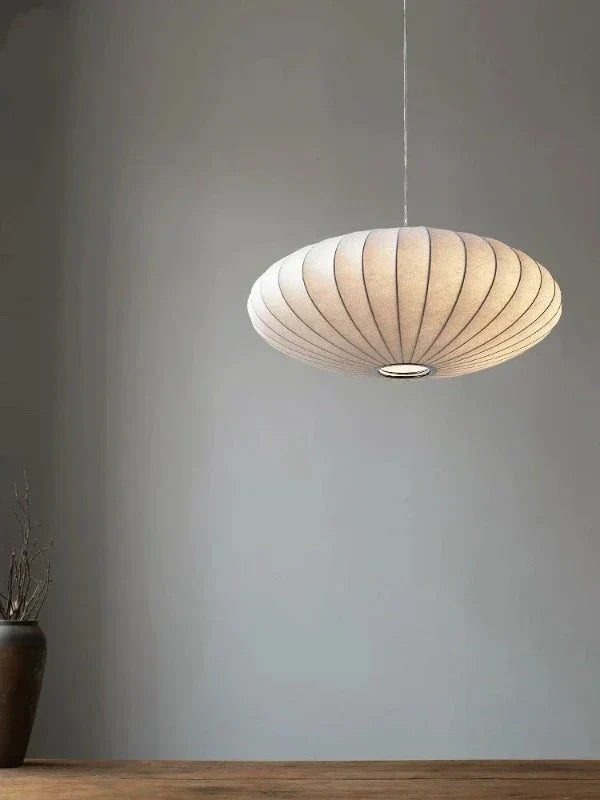 Stylish SilkCrown crystal pendant lamp with silk shade, modern ambient lighting for luxury homes.