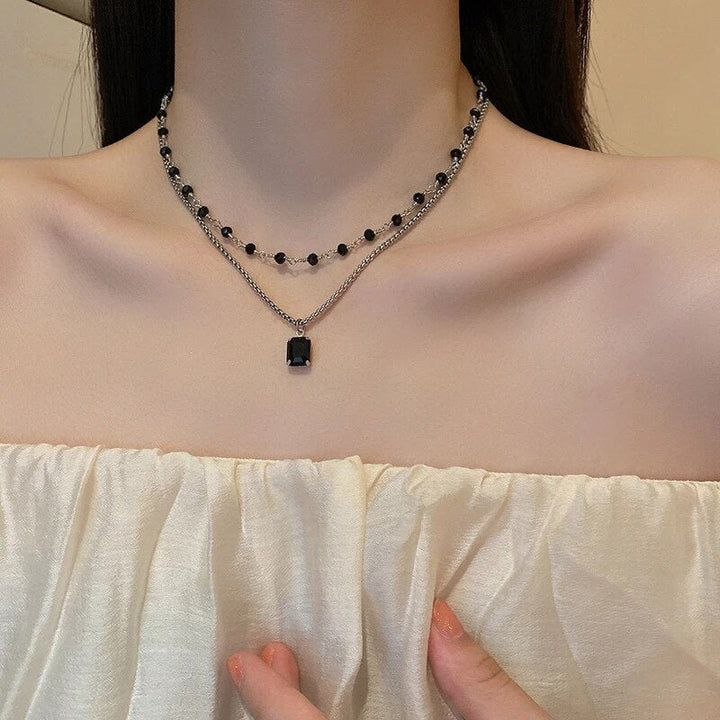 Stylish silver double chain necklace for women, showcasing a black pearl. An elegant and adjustable gift for her.