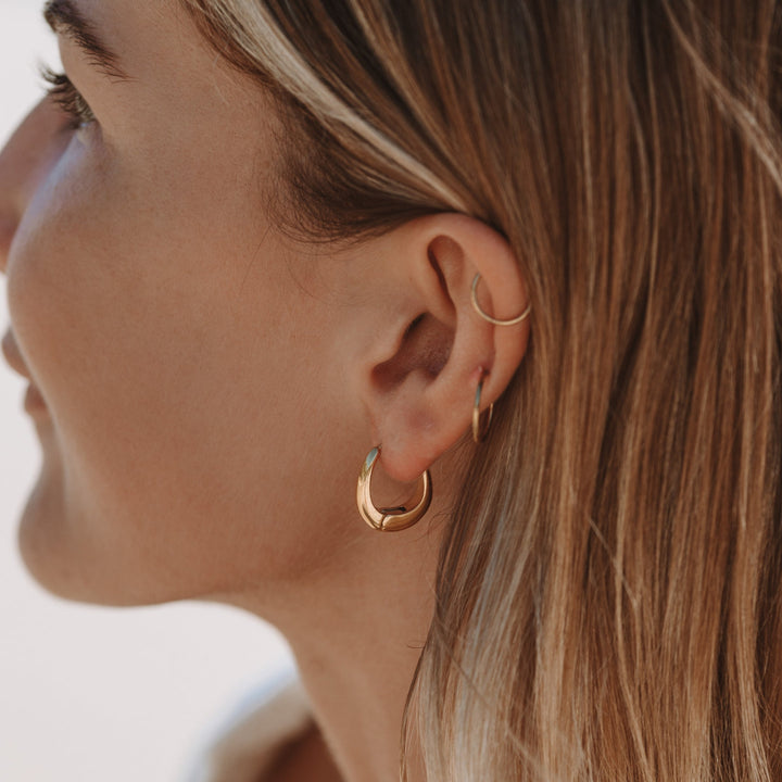Close-up of elegant Isla droplet earrings, showcasing the smooth, polished finish for a refined look.