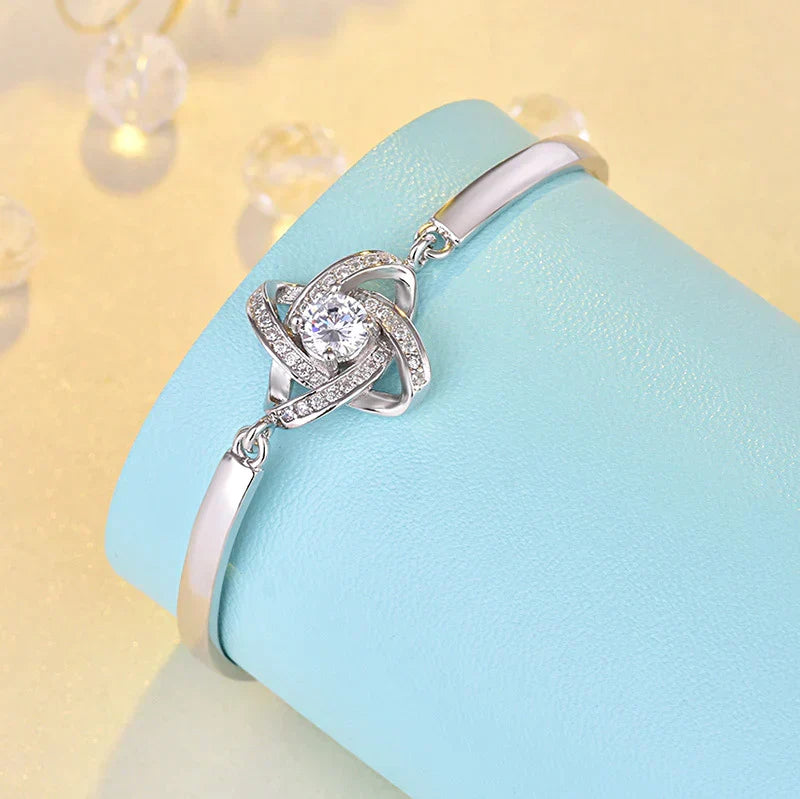 Elegant silver love knot bracelet for women, adjustable chain, stainless steel, perfect fashion accessory.