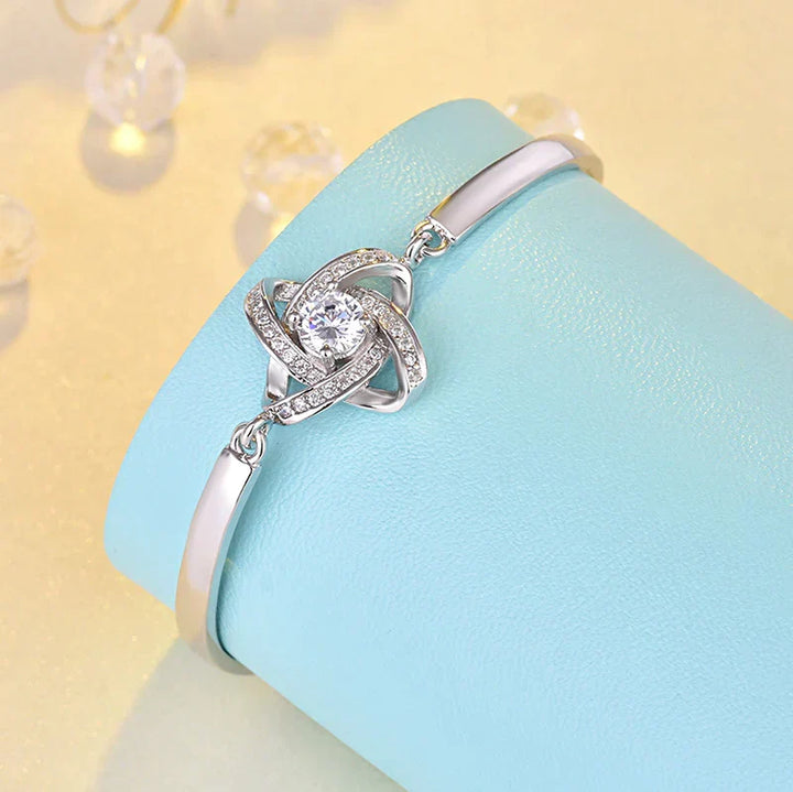 Elegant silver love knot bracelet for women, adjustable chain, stainless steel, perfect fashion accessory.