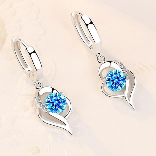 Elegant silver zircon earrings for women, sparkling jewelry perfect for any occasion. A stylish accessory.