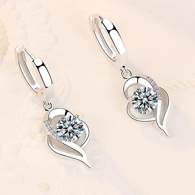 Elegant silver earrings with sparkling pink zircon stones, a stylish accessory for women.