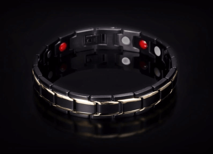 Stainless steel magnetic therapy bracelet on a wrist, showcasing modern unisex style