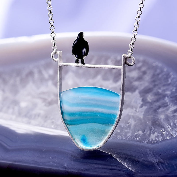 Stylish women's silver pendant necklace with a polished natural agate gemstone, a fashionable accessory.