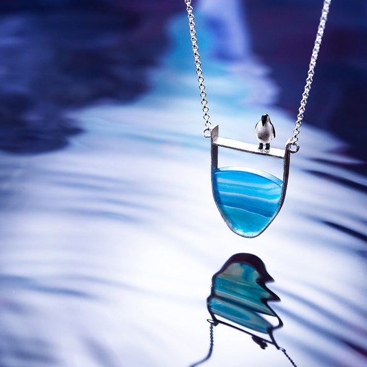 Delicate sterling silver chain with a unique natural agate pendant, an elegant women's fashion accessory.
