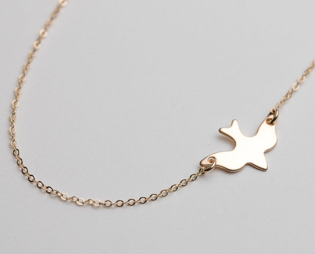 Elegant sterling silver bird necklace for women, symbolizing freedom and grace. Delicate animal jewelry gift.
