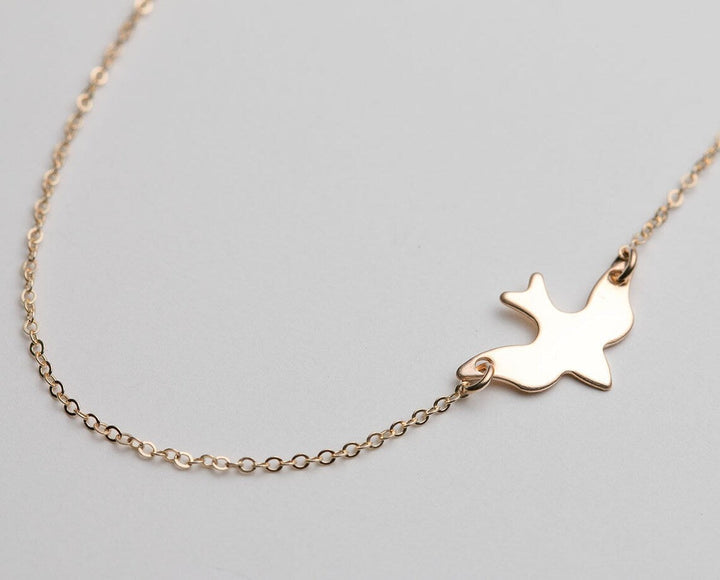 Elegant sterling silver bird necklace for women, symbolizing freedom and grace. Delicate animal jewelry gift.
