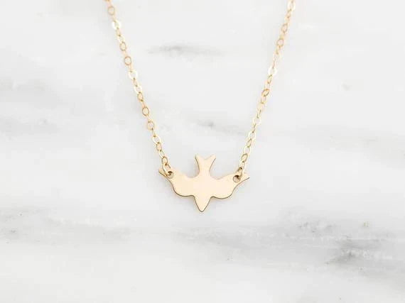 Graceful sterling silver bird necklace, a delicate symbol of freedom. Elegant women's animal jewelry.