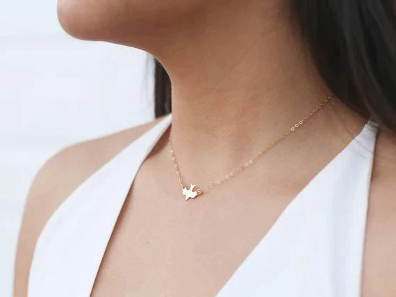 Women's elegant sterling silver bird necklace. Delicate jewelry gift for animal lovers, representing freedom.