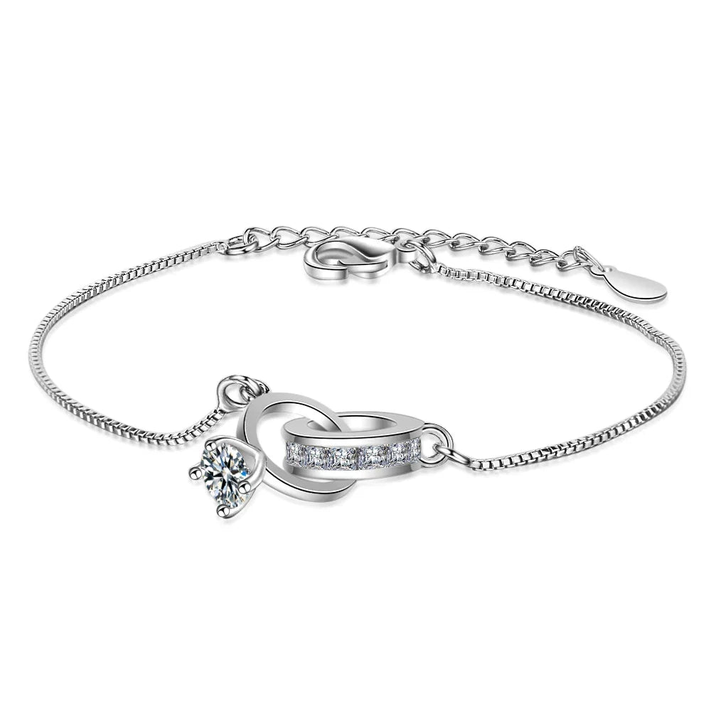Elegant sterling silver bracelet with a wedding ring pendant, adjustable for women. Perfect versatile jewelry gift.