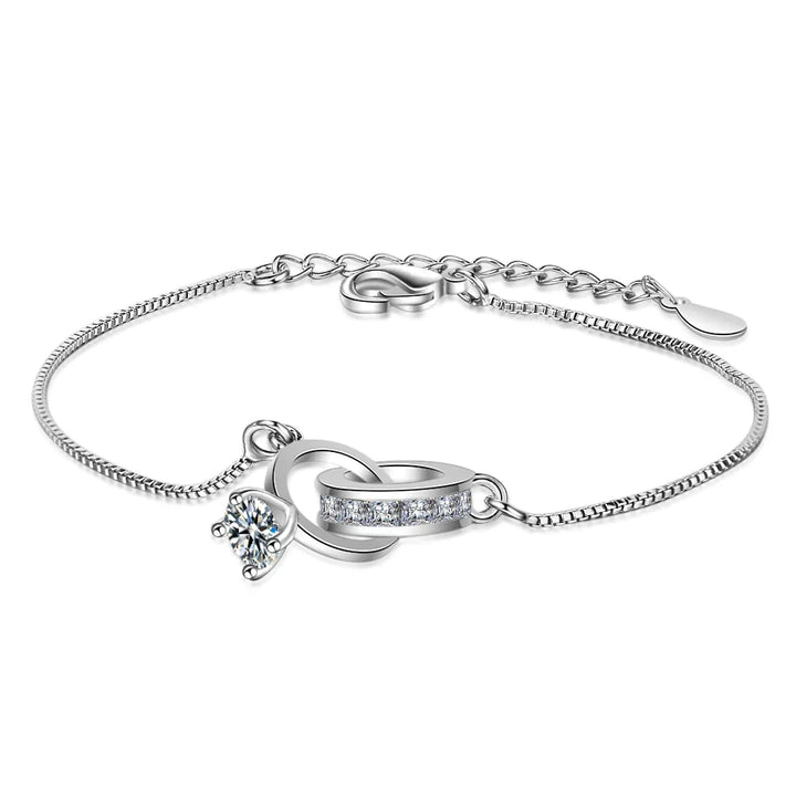 Elegant sterling silver bracelet with a wedding ring pendant, adjustable for women. Perfect versatile jewelry gift.
