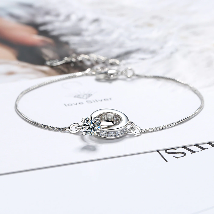 Women's elegant wedding bracelet featuring a delicate ring pendant in sterling silver. Versatile for any occasion.