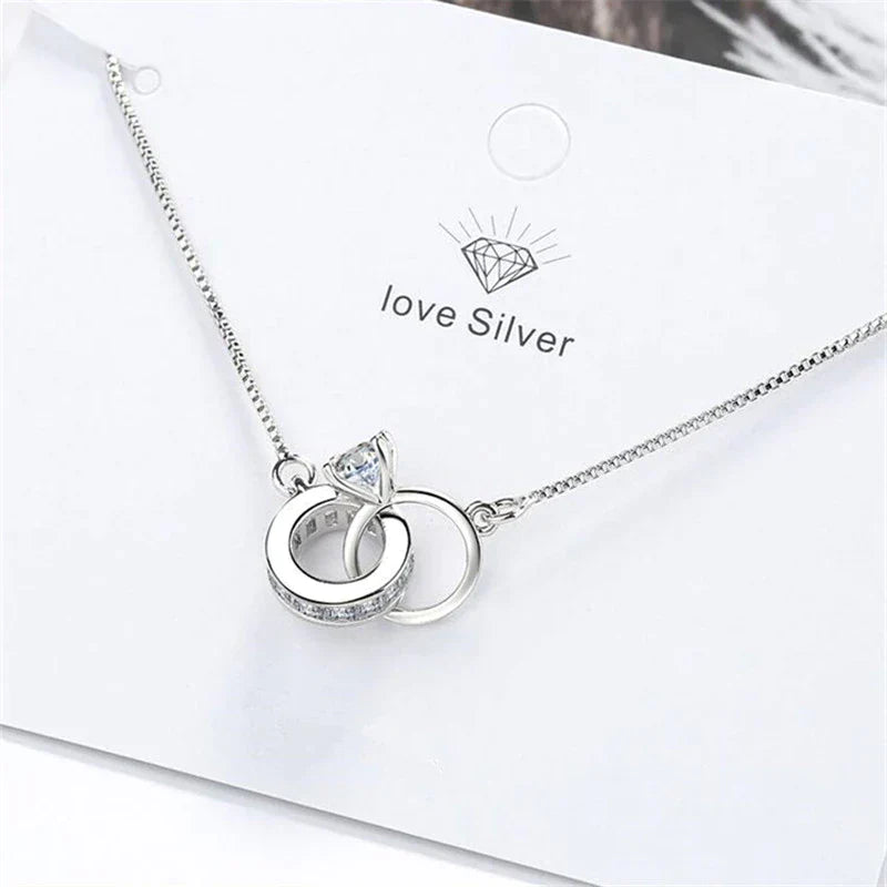 Adjustable sterling silver bracelet for women, with an elegant wedding ring pendant. Versatile and stylish jewelry.