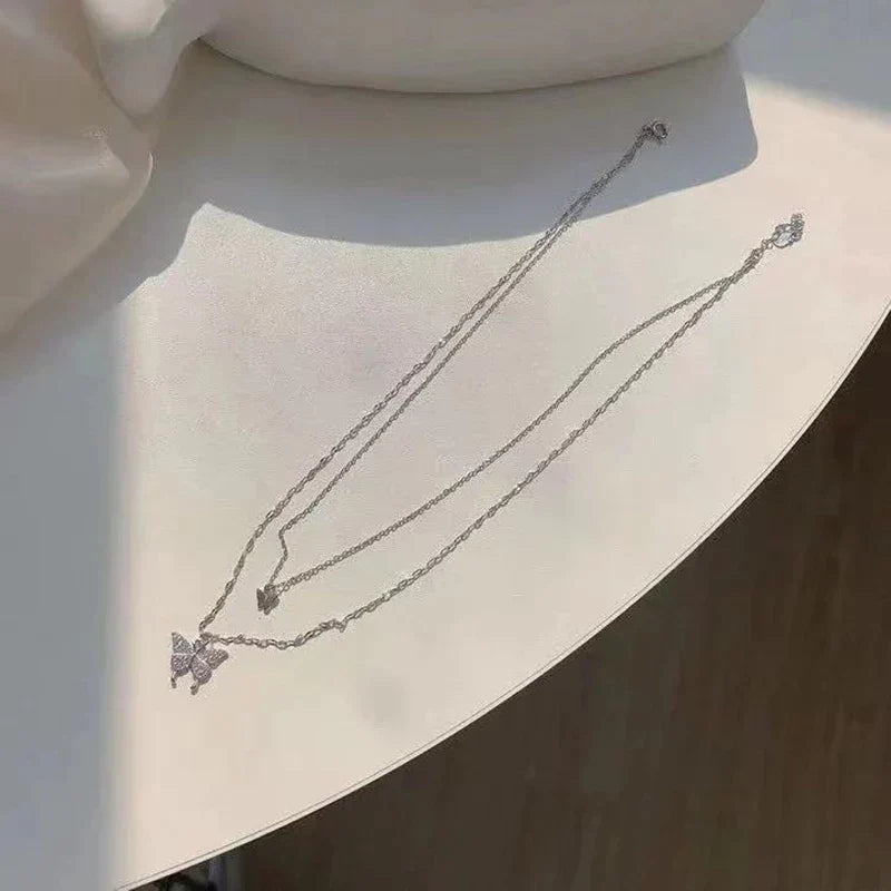 Delicate sterling silver butterfly necklace, a shimmering and elegant piece of women's fashion jewelry.