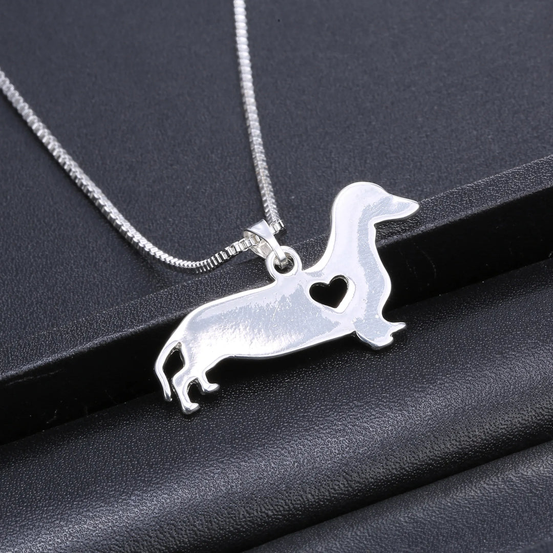 Fine sterling silver women's necklace featuring a cute dachshund in a heart pendant, elegant animal jewelry.