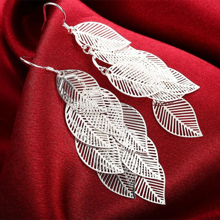 Elegant sterling silver delicate layered leaf dangle earrings for women. Nature-inspired fine jewelry.