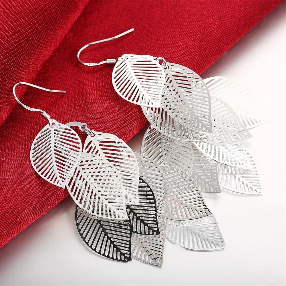 Delicate layered leaf earrings for women, sterling silver dangle style. Nature-inspired elegant jewelry.