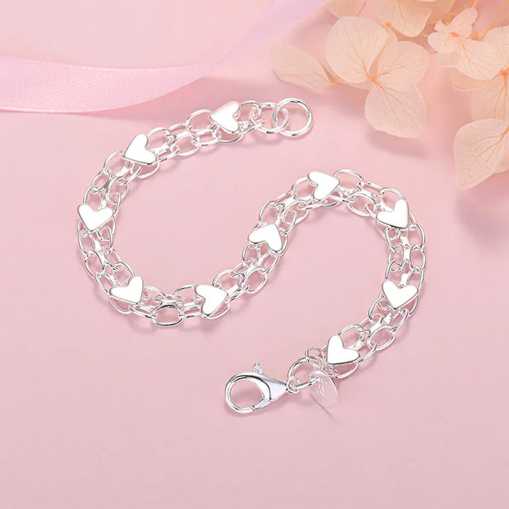 Elegant sterling silver heart bracelet for women. A classic adjustable silver accessory, perfect fine jewelry gift for her.