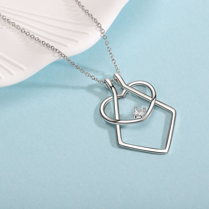 Women's sterling silver heart pendant ring holder necklace, featuring sparkling cubic zirconia for an elegant look.