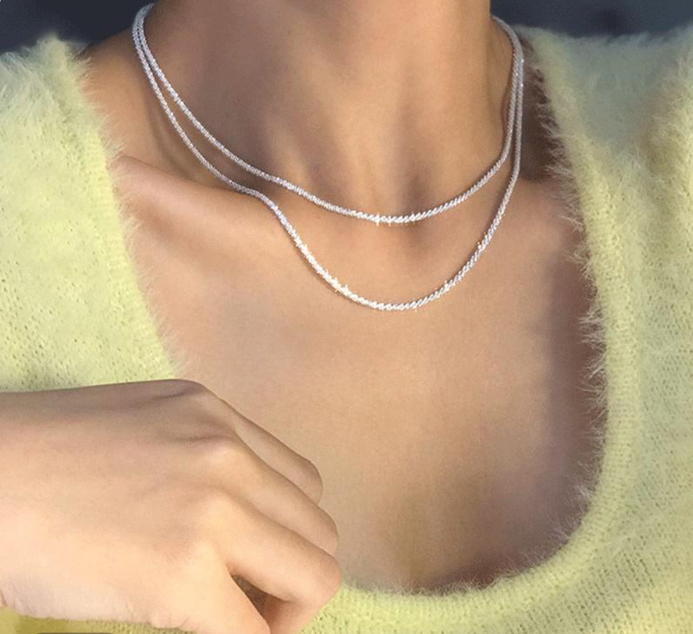 Close-up of an exquisite women's starlight sterling silver necklace, showcasing its elegant design and brilliant shine.