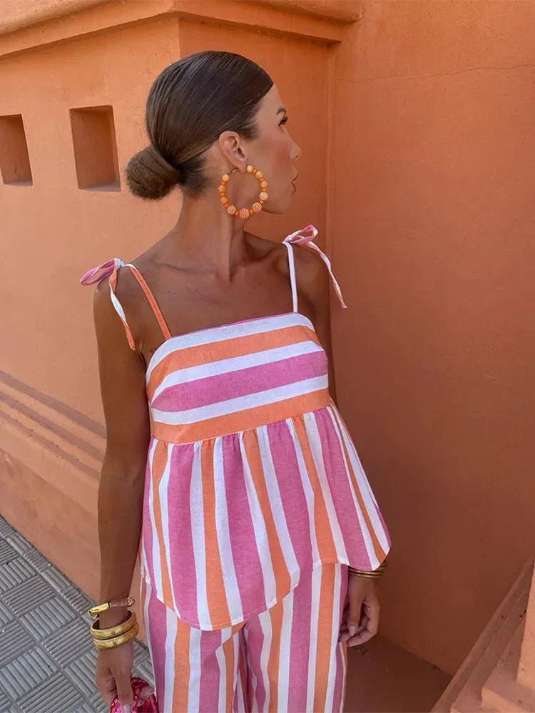 Striped wide leg wedding guest dress with peplum cami and trousers, an elegant and chic two-piece ensemble.
