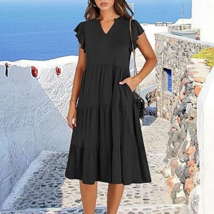 Stylish women's V-neck tiered midi dress, featuring elegant flutter sleeves. Comfortable & versatile for casual or dressy occasions.
