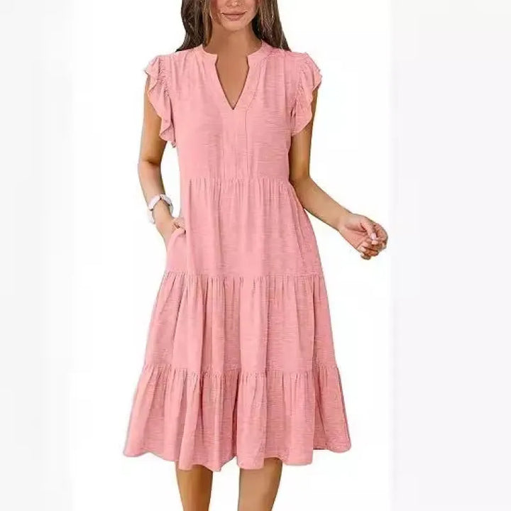 Flowy tiered midi dress with a flattering V-neck and delicate flutter sleeves, ideal for comfortable spring/summer style.