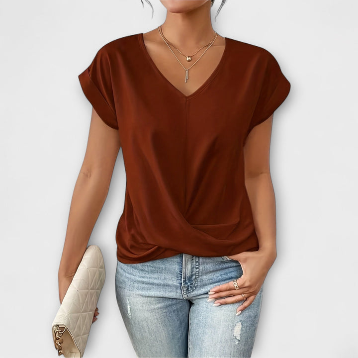 Elegant V-neck women's top with stylish button detail, long sleeve, versatile for casual or chic wear.