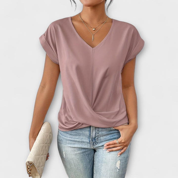 Flattering women's V-neck top, versatile fashion with elegant button detail, perfect for everyday wear.