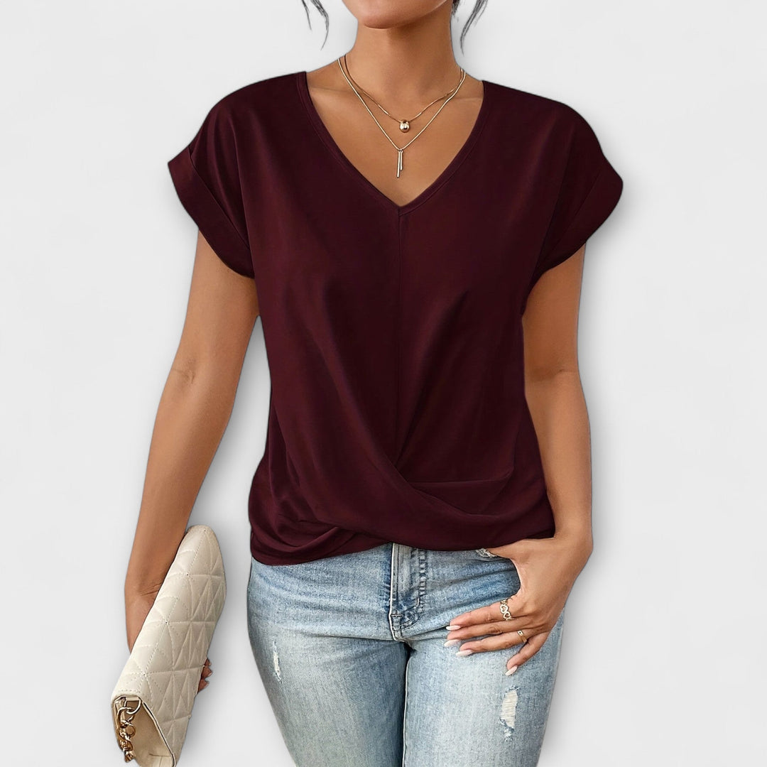 Womens apparel: sophisticated V-neck top with unique button detail, long sleeves, great for any occasion.
