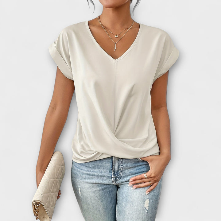 Modern women's V-neck top, elegant design with flattering button detail, versatile long sleeve for fashion.