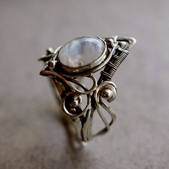 Close-up of a women's vintage moonstone ring, showcasing the silver setting & gemstone's unique shimmer.