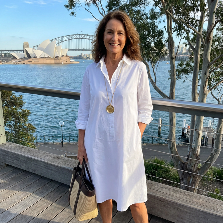 Sophisticated women's white midi dress with a button-down front, offering timeless elegance for both casual and formal wear.