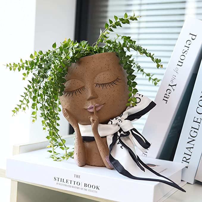 Decorative goddess head planter pot, white resin, suitable for indoor plant displays or outdoor garden decor.
