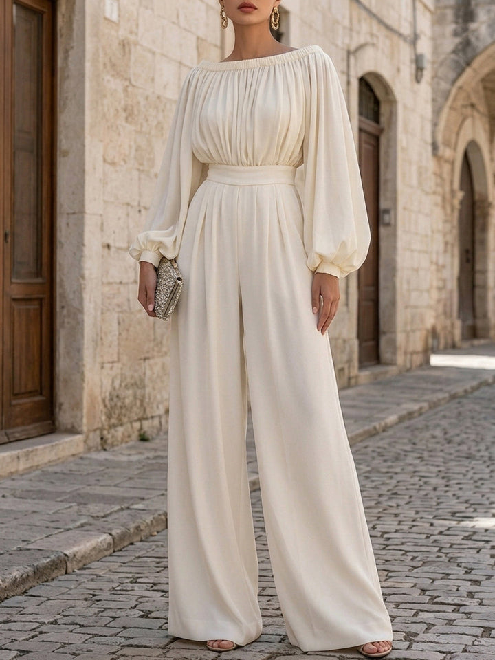 Flowing white off-shoulder maxi dress for women, elegant design with bishop sleeves. Great for special occasions.