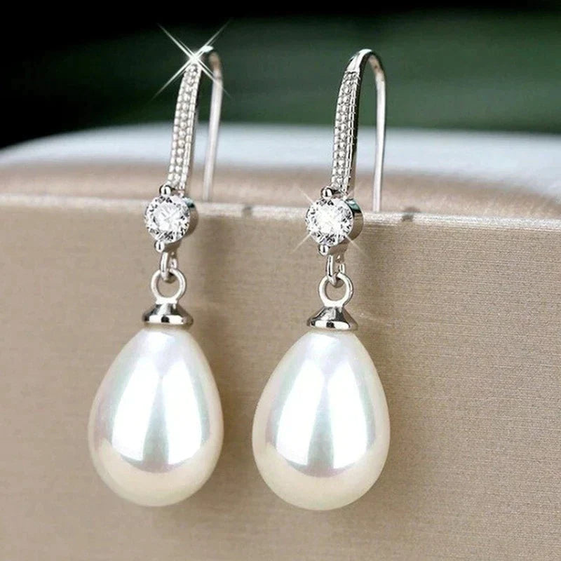 Classic women's white oval pearl earrings with sterling silver. Perfect elegant gift jewelry for a timeless look.