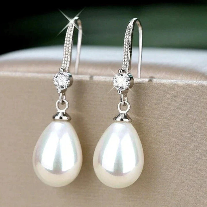 Classic women's white oval pearl earrings with sterling silver. Perfect elegant gift jewelry for a timeless look.