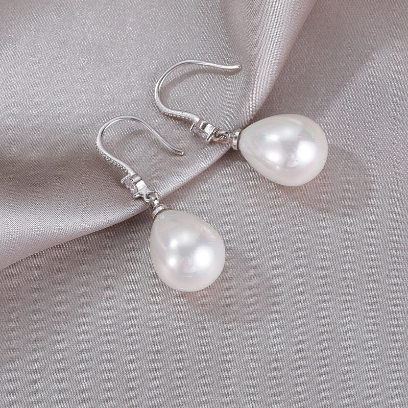 Beautiful white oval pearl drop earrings for women. Elegant sterling silver design, perfect classic jewelry gift.