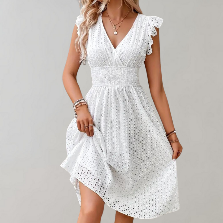 Comfortable white short summer dress with delicate ruffled sleeves, ideal for a chic and relaxed look.