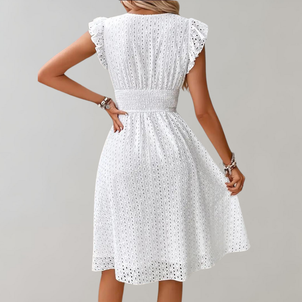 Flowy white summer dress with ruffled sleeves, a perfect vacation outfit for women seeking comfort & style.
